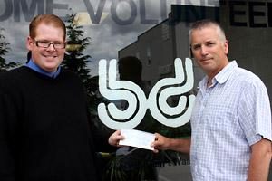 HATS OFF: Bruce Denniston Bone Marrow Society president Garry Anderson [left] accepts a cheque for $1000 from Bill Grantham of the Powell River Professional Fire Fighters Charitable Society. The money will go towards upgrades to the Powell River General Hospital’s oncology room.